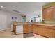 Kitchen view includes granite countertops and plenty of wooden cabinet space, with a view into the living room at 10241 Premia Pl, Las Vegas, NV 89135