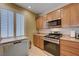 Kitchen with stainless steel appliances, granite countertops, and shaker style cabinets providing plenty of storage at 10241 Premia Pl, Las Vegas, NV 89135