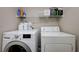 Laundry room features a stacked washer/dryer set and wire shelving at 10241 Premia Pl, Las Vegas, NV 89135
