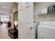 Laundry room is located off a hallway with a washer/dryer set and wire shelving at 10241 Premia Pl, Las Vegas, NV 89135
