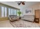 This well-lit living room showcases plush seating, natural light from the windows, and a decorative area rug at 10241 Premia Pl, Las Vegas, NV 89135