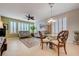 Bright living room features tile flooring, plantation shutters, comfortable seating, and decorative ceiling fan at 10241 Premia Pl, Las Vegas, NV 89135