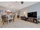 Spacious living area featuring tile flooring and an entertainment center, creating a comfortable and inviting atmosphere at 10241 Premia Pl, Las Vegas, NV 89135