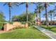 Charming Village Center sign surrounded by palm trees and lush green landscaping at 10241 Premia Pl, Las Vegas, NV 89135