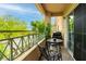 Inviting balcony area with outdoor seating, barbecue grill, and beautiful green tree views at 10500 Pine Pointe Ave # 206, Las Vegas, NV 89144
