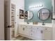 This well-lit bathroom offers dual sinks, stylish mirrors, modern fixtures, and access to a shower and toilet at 10500 Pine Pointe Ave # 206, Las Vegas, NV 89144