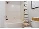 Bright bathroom featuring a tiled bathtub with shower, toilet, and contemporary fixtures and design at 10500 Pine Pointe Ave # 206, Las Vegas, NV 89144
