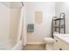 Bright bathroom features a white vanity, decorative shelving, and shower-tub combo at 10500 Pine Pointe Ave # 206, Las Vegas, NV 89144