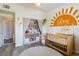 This vibrant Bedroom features a cozy crib, storage, and playful decorations that create a warm atmosphere at 10500 Pine Pointe Ave # 206, Las Vegas, NV 89144