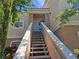 Inviting condo entrance with outdoor stairs and covered porch offering curb appeal at 10500 Pine Pointe Ave # 206, Las Vegas, NV 89144
