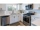 Updated kitchen equipped with stainless steel appliances, white cabinets, and stylish fixtures at 10500 Pine Pointe Ave # 206, Las Vegas, NV 89144