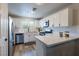 Modern kitchen featuring white cabinets, stainless steel appliances, and quartz countertops at 10500 Pine Pointe Ave # 206, Las Vegas, NV 89144