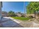 Backyard features a patio, manicured lawn area, block wall, and mature trees at 10654 Robin Hill Ave, Las Vegas, NV 89129