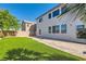 A generous backyard features lawn, patio, mature trees, and block wall with easy access door at 10654 Robin Hill Ave, Las Vegas, NV 89129