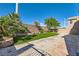 Low maintenance backyard features manicured lawn area, mature trees, a block wall and patio at 10654 Robin Hill Ave, Las Vegas, NV 89129