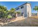 Large private backyard with mature landscaping, patio, easy access door, and a block wall at 10654 Robin Hill Ave, Las Vegas, NV 89129