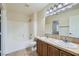 Bright bathroom featuring a double sink vanity, large mirror, and bathtub with shower at 10654 Robin Hill Ave, Las Vegas, NV 89129