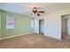 Bedroom with carpet, closet, ceiling fan, and two bright windows providing ample natural light at 10654 Robin Hill Ave, Las Vegas, NV 89129