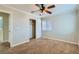 Bedroom with closet, ceiling fan, carpet, and bright window offering natural light at 10654 Robin Hill Ave, Las Vegas, NV 89129
