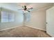 Bedroom with carpet, ceiling fan and two windows providing ample natural light at 10654 Robin Hill Ave, Las Vegas, NV 89129
