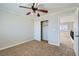 Bedroom with ceiling fan, closet, plush carpet, and an open doorway to the hall at 10654 Robin Hill Ave, Las Vegas, NV 89129