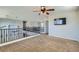 Bonus room featuring carpet, neutral walls, ceiling fan, and wrought iron banister at 10654 Robin Hill Ave, Las Vegas, NV 89129