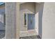 Covered entry featuring a light blue front door, textured stucco walls, and brick paving at 10654 Robin Hill Ave, Las Vegas, NV 89129