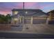 Two-story home featuring a three-car garage, mature landscaping, and decorative stone accents at 10654 Robin Hill Ave, Las Vegas, NV 89129