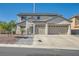 Home exterior featuring a two-car garage, walkway, and neutral stucco finish, under a clear blue sky at 10654 Robin Hill Ave, Las Vegas, NV 89129