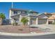 Two-story home showcasing a two-car garage, landscaped front yard, and attractive neutral-toned stucco at 10654 Robin Hill Ave, Las Vegas, NV 89129