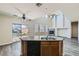 Open kitchen with granite countertops, stainless appliances, and views into the spacious living room at 10654 Robin Hill Ave, Las Vegas, NV 89129