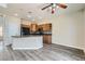 Well-lit kitchen with a center island, granite countertops, wood cabinets, and black appliances at 10654 Robin Hill Ave, Las Vegas, NV 89129