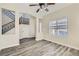 Inviting living room with staircase, wood-look floors, and a large window at 10654 Robin Hill Ave, Las Vegas, NV 89129