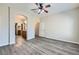 The main bedroom offers wood-look floors and an ensuite bathroom with dual sinks and shower at 10654 Robin Hill Ave, Las Vegas, NV 89129