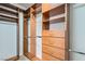 Spacious walk-in closet with custom wood shelving, drawers, and ample hanging space at 10654 Robin Hill Ave, Las Vegas, NV 89129