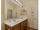 Bright bathroom with double sinks, large mirror, and modern fixtures create a spa-like feel at 10858 Morning Frost St, Las Vegas, NV 89179