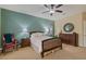 Bedroom featuring stylish teal accent wall, wood-framed bed, dresser, and ceiling fan, creating a cozy space at 10858 Morning Frost St, Las Vegas, NV 89179