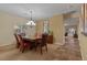Inviting dining room featuring a large wooden table, elegant chandelier, and neutral color scheme at 10858 Morning Frost St, Las Vegas, NV 89179
