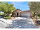 Charming single-story home featuring a well-manicured yard and attached two-car garage at 10858 Morning Frost St, Las Vegas, NV 89179