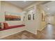 Inviting hallway with tile flooring, built-in seating, and stylish wall decor at 10858 Morning Frost St, Las Vegas, NV 89179