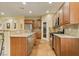 Well-equipped kitchen with stainless steel appliances, granite counters, and natural wood cabinets at 10858 Morning Frost St, Las Vegas, NV 89179