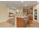 Open kitchen design with stainless appliances, granite countertops, and breakfast bar seating at 10858 Morning Frost St, Las Vegas, NV 89179