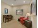Cozy office space with a desk, comfortable armchair, and natural light from the window at 10858 Morning Frost St, Las Vegas, NV 89179