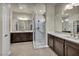 Elegant bathroom featuring dual sinks, marble countertops and a walk-in shower at 1108 Via Della Curia, Henderson, NV 89011