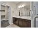Bathroom featuring a double vanity, marble countertop, and access to a walk-in closet at 1108 Via Della Curia, Henderson, NV 89011