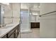 Stylish bathroom boasting dual sinks, a glass shower enclosure and a walk-in closet at 1108 Via Della Curia, Henderson, NV 89011