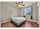 This bedroom has hardwood floors, a ceiling fan, and a window with natural light at 1108 Via Della Curia, Henderson, NV 89011