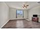 Bright bedroom featuring hardwood floors, a ceiling fan, and a large window at 1108 Via Della Curia, Henderson, NV 89011