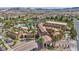 Stunning aerial view of a luxurious community clubhouse with a pool and lush palm trees in a beautiful neighborhood at 1108 Via Della Curia, Henderson, NV 89011