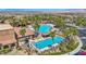 Stunning aerial view of a community pool with a lap pool and waterfall feature surrounded by mature trees and residences at 1108 Via Della Curia, Henderson, NV 89011